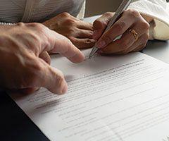 Woman signing paperwork